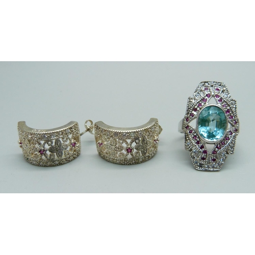 1035 - A silver topaz and ruby ring, Q, and a pair of silver and ruby earrings