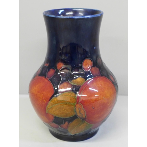 606 - A Moorcroft Pomegranate pattern vase, 12.5cm