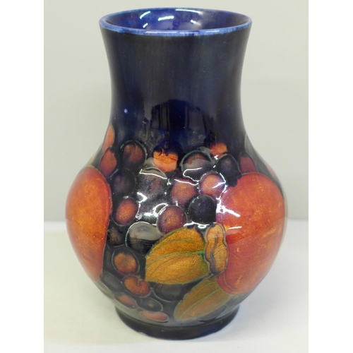 606 - A Moorcroft Pomegranate pattern vase, 12.5cm