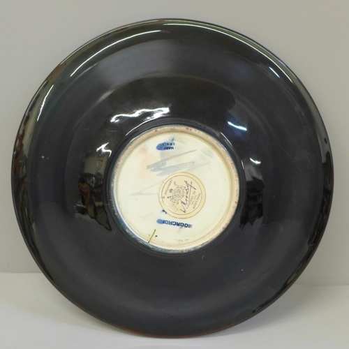 608 - An early 20th Century Moorcroft Burgundy Clematis shallow bowl, paper label to base, 24cm