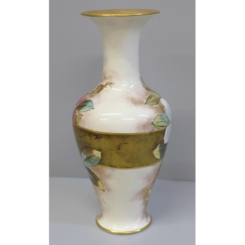 616 - A Doulton Christmas Rose faience vase, registration lozenge to base, 19.5cm