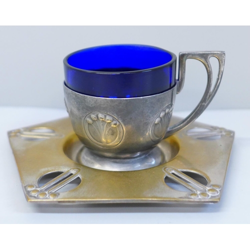 648 - A WMF Art Nouveau cup and saucer with blue glass liner