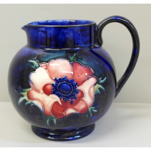 649 - A Moorcroft Peony pattern jug in cobalt blue, 12cm, with a box