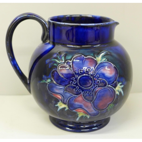 649 - A Moorcroft Peony pattern jug in cobalt blue, 12cm, with a box