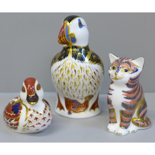 650 - Three Royal Crown Derby paperweights, Puffin (second), cat with gold hexagonal stopper and duckling ... 