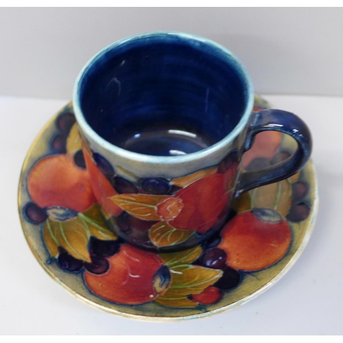 652 - An early 20th Century Moorcroft Pomegranate pattern coffee can and saucer