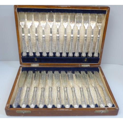 680 - A set of twenty-four boxed fish knives and forks