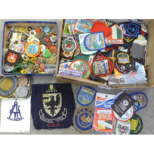 686 - A large collection of cloth and enamel badges including Scouting