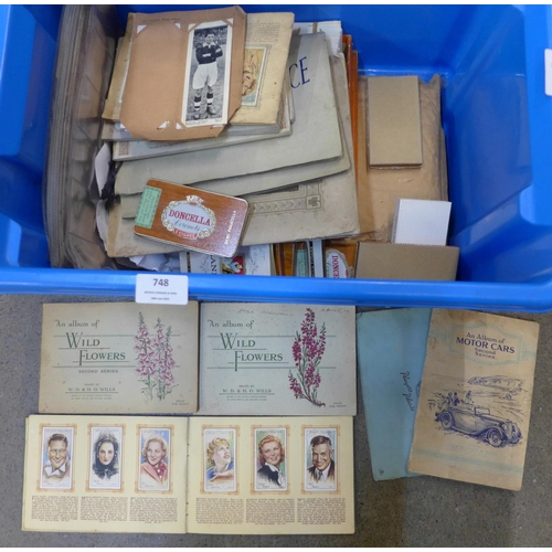 748 - A box of cigarette cards, albums, Doncella cigar cards, Topical Times football cards, etc.