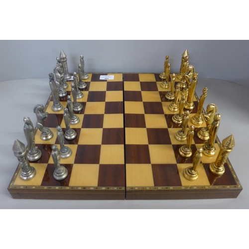 766 - A chess set and board/box, medieval style pieces, one Queen missing