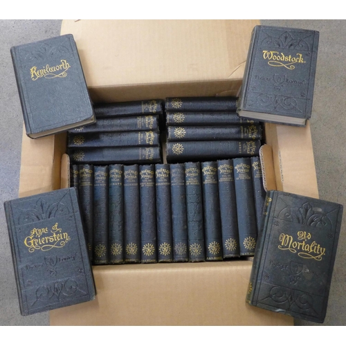 769 - Twenty-five volumes of Walter Scott The Waverley Novels, green cloth covers, embossed front and rear... 