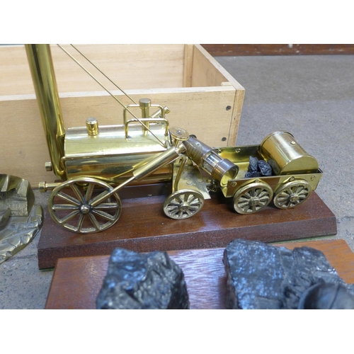 786 - A brass model of Stephenson's Rocket, brass model of a miner, two miniature miner's lamps, mining ho... 