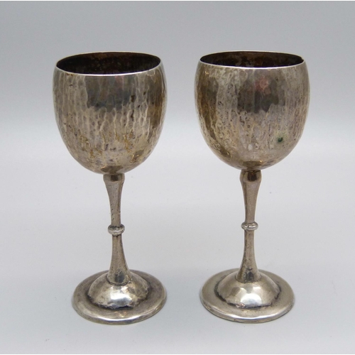 855 - A pair of small hammered 900 silver goblets, 45g