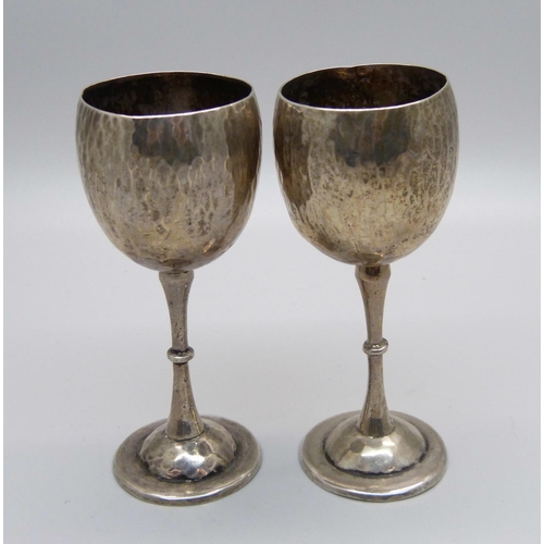 855 - A pair of small hammered 900 silver goblets, 45g