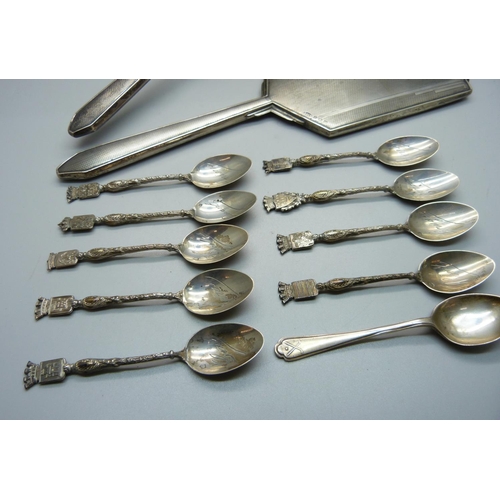 863 - A silver backed Art Deco hand mirror, a brush, a hallmarked silver spoon and nine white metal spoons... 