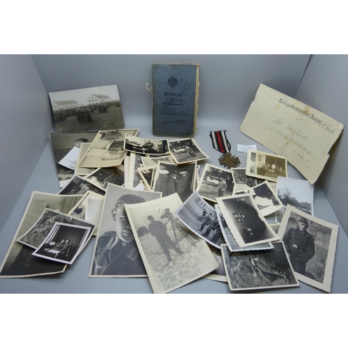 875 - A German medal marked 1914-1918, plates, an early 20th Century service book and a collection of mili... 