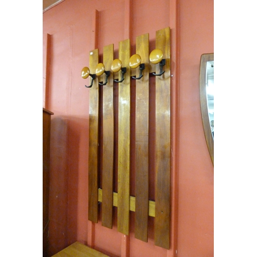 10 - A teak wall hanging coat rack