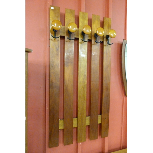 10 - A teak wall hanging coat rack