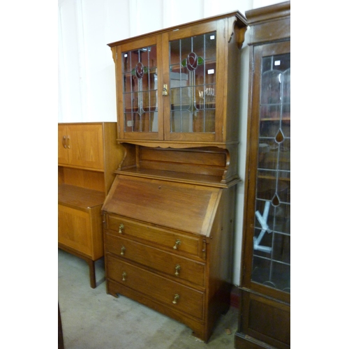 100 - An Arts and Crafts walnut bureau bookcase