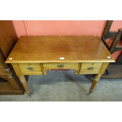 110 - A Victorian mahogany three drawer writing table