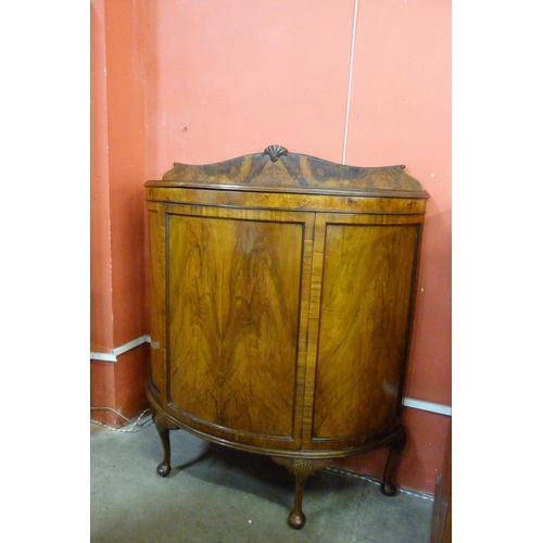 115 - A Queen Anne style figured walnut demi-lune side cabinet