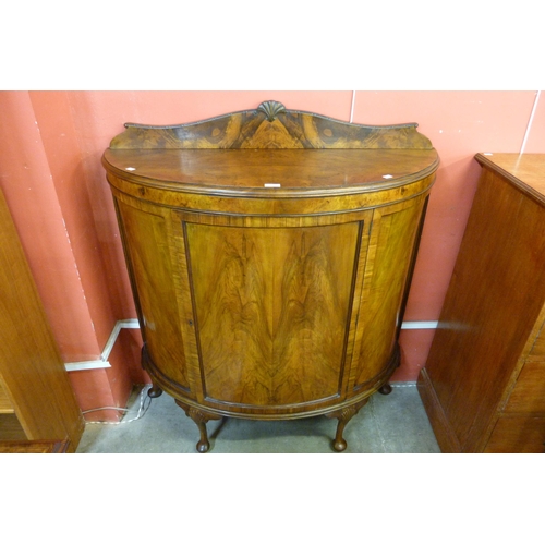 115 - A Queen Anne style figured walnut demi-lune side cabinet