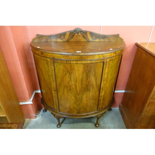 115 - A Queen Anne style figured walnut demi-lune side cabinet