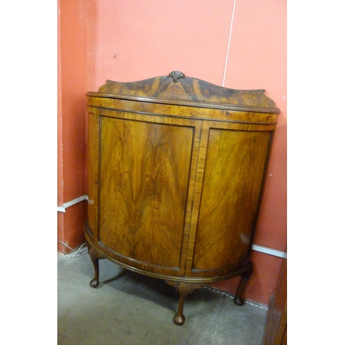 115 - A Queen Anne style figured walnut demi-lune side cabinet