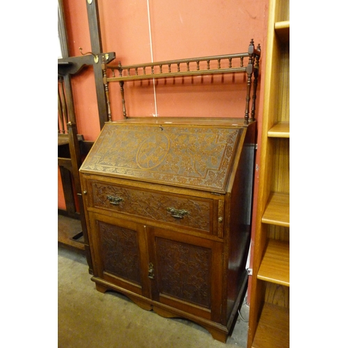 116 - A Victorian Aesthetic Movement carved walnut bureau