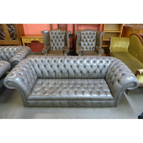 120 - A grey leather Chesterfield settee