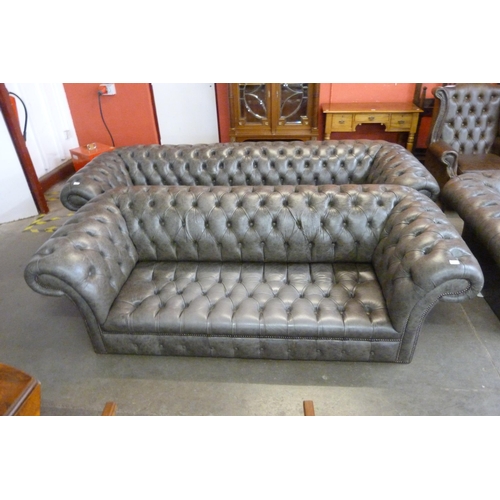 121 - A grey leather Chesterfield settee