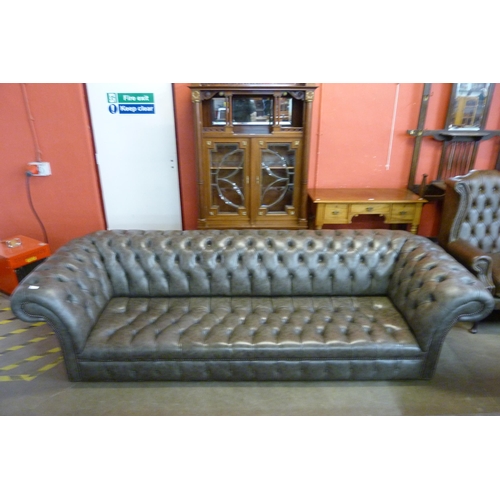 122 - A grey leather Chesterfield settee