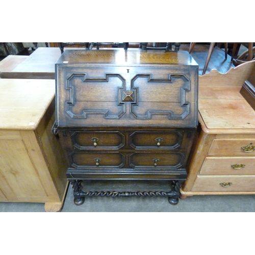 137 - An early 20th Century oak geometric moulded bureau