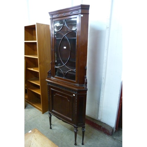 147 - An Edward VII carved mahogany freestanding splay front corner cabinet