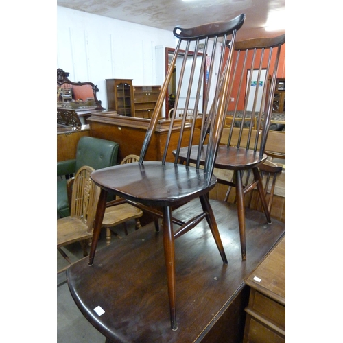 148B - An Ercol dark elm drop-leaf table and three chairs