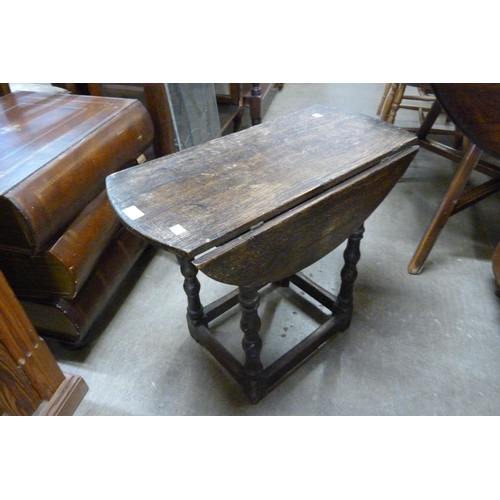 149 - A small 17th Century and later oak drop-leaf table