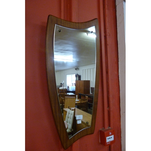 16 - An asymmetrical teak framed mirror