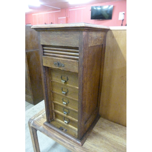 160 - A Victorian oak fitted tambour front index drawer cabinet