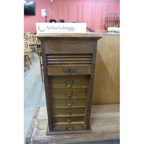 160 - A Victorian oak fitted tambour front index drawer cabinet