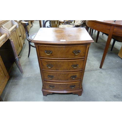 169 - A small burr walnut bow front chest of drawers