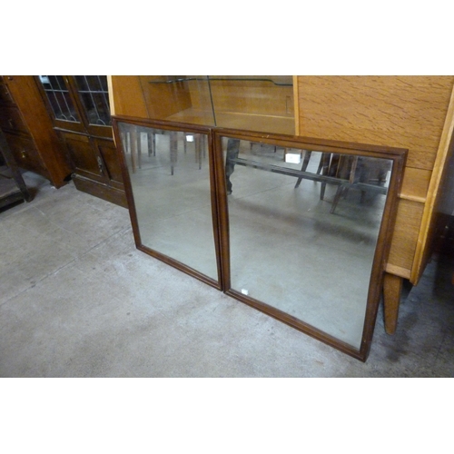 19 - A pair of teak framed mirrors