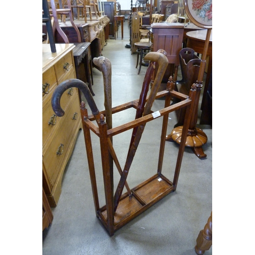 191 - An oak stick stand and four walking canes