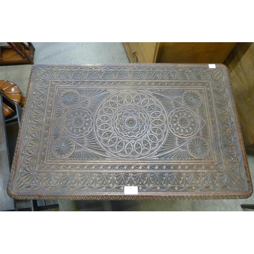 194 - An eastern carved hardwood occasional table