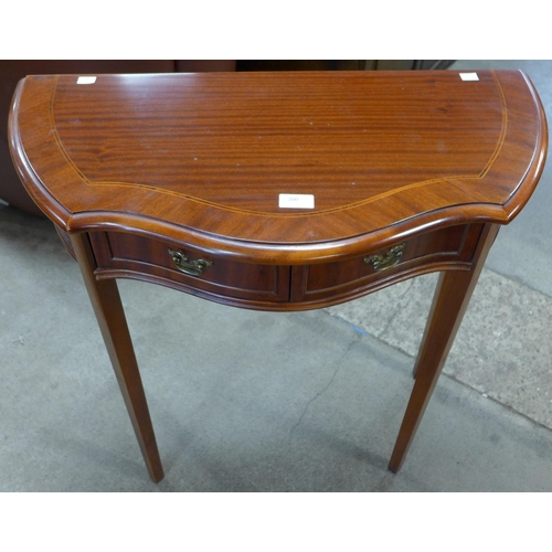 200 - A mahogany serpentine two drawer hall table