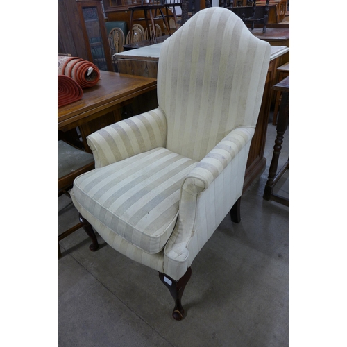 217 - A pair of Queen Anne style mahogany and striped fabric upholstered wingback armchairs