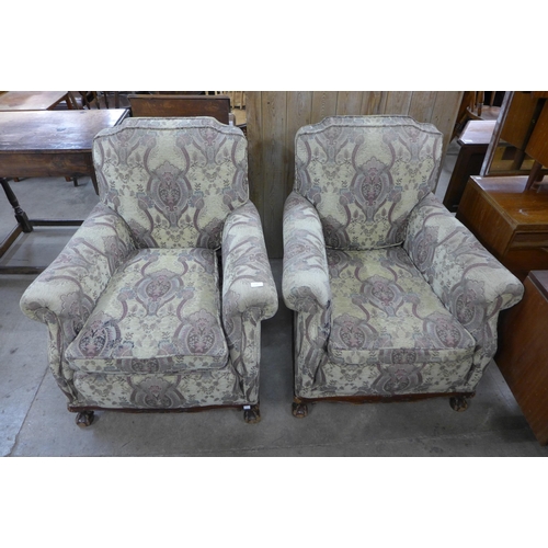 218 - A pair of early 20th Century Chippendale Revival carved mahogany and fabric upholstered armchairs