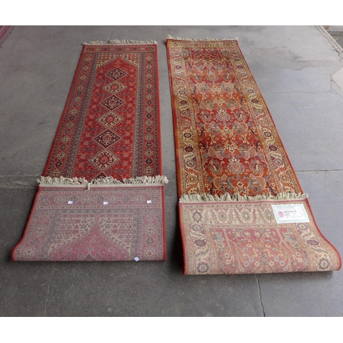 219 - Two red ground runner rugs