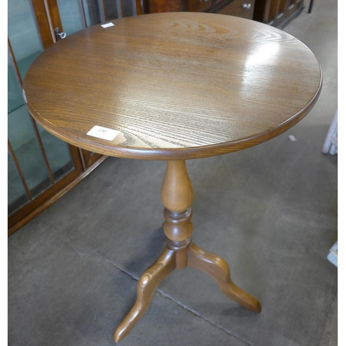 230 - An Ercol Golden Dawn elm tripod table