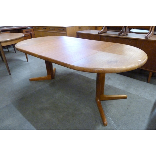 27 - A Danish teak extending dining table