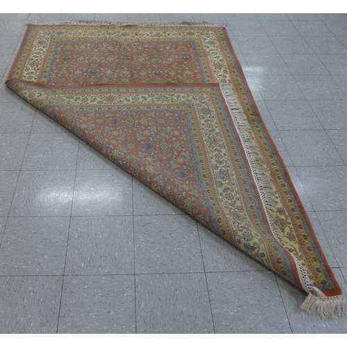 276 - An eastern terracotta ground rug